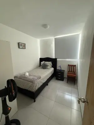 a small bedroom with a bed and a chair at Beautiful Ocean view apartment in Cartagena de Indias