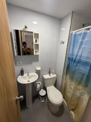 a bathroom with a toilet and a sink and a mirror at Beautiful Ocean view apartment in Cartagena de Indias