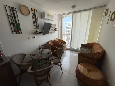 a dining room with a table and chairs and a window at Beautiful Ocean view apartment in Cartagena de Indias