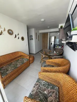 a living room with wicker chairs and a table at Beautiful Ocean view apartment in Cartagena de Indias