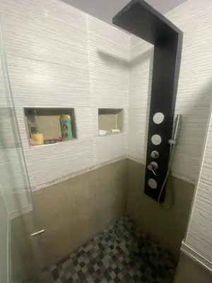 a bathroom with a shower with a glass door at Casa de lujo en barrio popular in Cartagena de Indias