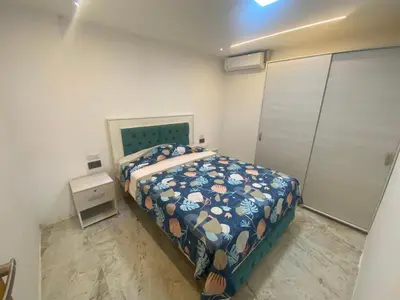 a bedroom with a bed with a blue comforter at Casa de lujo en barrio popular in Cartagena de Indias