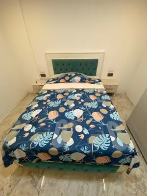 a bedroom with a bed with a blue and orange comforter at Casa de lujo en barrio popular in Cartagena de Indias