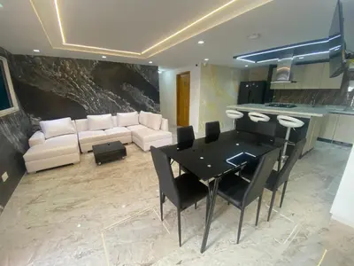 a kitchen and living room with a table and a couch at Casa de lujo en barrio popular in Cartagena de Indias