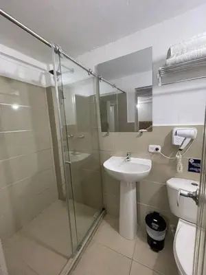 a bathroom with a shower and a sink and a toilet at HS-T Habitacion Triple con wifi, piscina y aire acondicionado in Cartagena de Indias