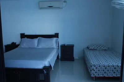 a bedroom with a bed and a blue light at Arriendos S.H. Nuevo Conquistador in Cartagena de Indias