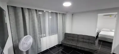 a room with a couch and a bed and a window at Apartamento en Bocagrande muy cerca al mar! Apto 401 in Cartagena de Indias