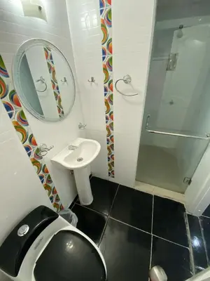 a bathroom with a toilet and a sink and a mirror at Apartamento en Bocagrande muy cerca al mar! Apto 401 in Cartagena de Indias