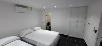 a small white room with a bed and a closet at Apartamento en Bocagrande muy cerca al mar! Apto 401 in Cartagena de Indias