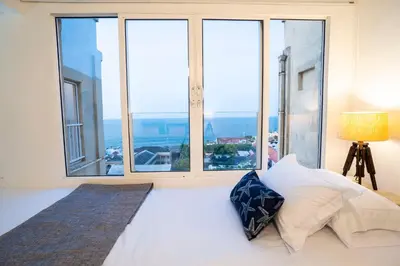 a bedroom with a bed with a large window at Renovated with ocean view in historic center! in Cartagena de Indias