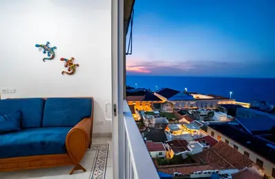 a living room with a blue couch and a window at Renovated with ocean view in historic center! in Cartagena de Indias