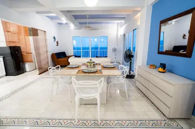 a kitchen and living room with a table and chairs at Renovated with ocean view in historic center! in Cartagena de Indias