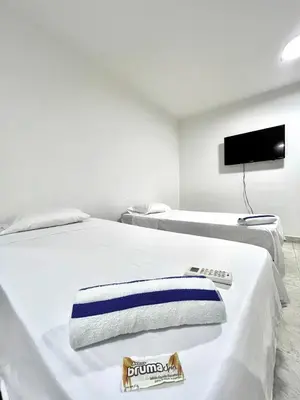 a hotel room with two beds and a flat screen tv at Comfortable loft in Barranquilla in Barranquilla