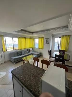 a living room with yellow curtains and a couch at Portofino Apartments in Cartagena de Indias