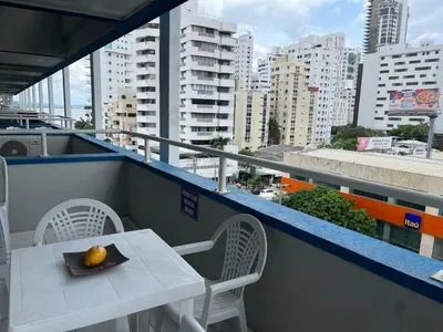 a table and chairs on a balcony with a view of a city at Portofino Apartments in Cartagena de Indias