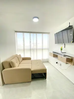 a living room with a couch and a flat screen tv at Hermoso apartamento amoblado in Barranquilla