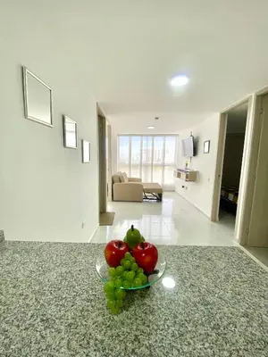 a bowl of fruit on a counter in a living room at Hermoso apartamento amoblado in Barranquilla
