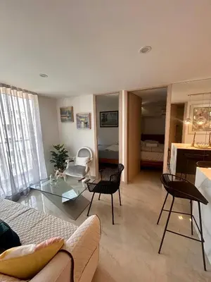 a living room with a couch and a glass table at Apto de lujo para estrenar in Barranquilla
