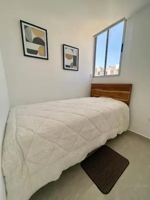 a bedroom with a bed and two pictures on the wall at Apto de lujo para estrenar in Barranquilla