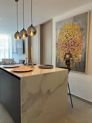 a kitchen with a counter with a painting on the wall at Apto de lujo para estrenar in Barranquilla