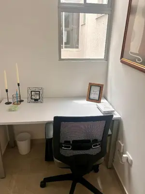 a white desk with a chair and a window at Apto de lujo para estrenar in Barranquilla