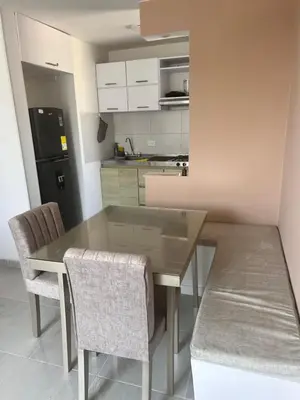 a kitchen with a dining room table and chairs at Cómodo apartamento en el norte de Barranquilla in Barranquilla
