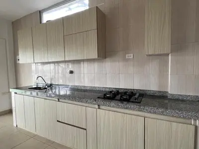 a kitchen with wooden cabinets and a counter top at Cabaña Don Jerónimo in Santa Veronica