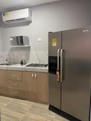 a kitchen with a stainless steel refrigerator and a stove at Apartaestudio altos de riomar in Barranquilla