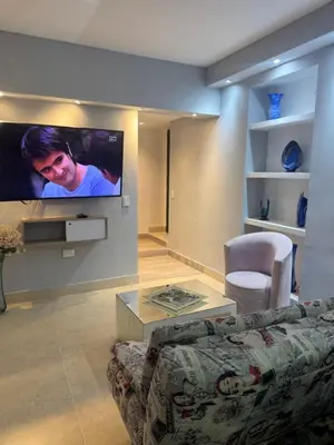 a living room with a couch and a flat screen tv at Apartaestudio altos de riomar in Barranquilla