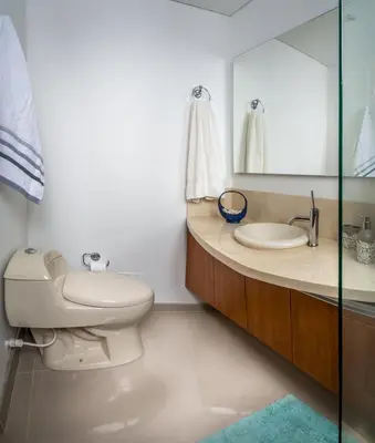 a bathroom with a toilet and a sink and a mirror at Apartamento con vista al mar - Condominio Zazué in Santa Marta