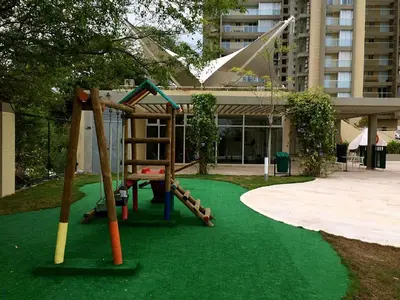 a playground with a slide on a green lawn at Apartamento con vista al mar - Condominio Zazué in Santa Marta