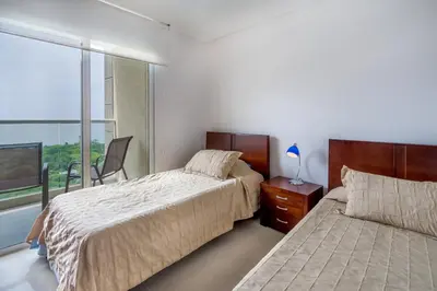 a bedroom with two beds and a window at Apartamento con vista al mar - Condominio Zazué in Santa Marta