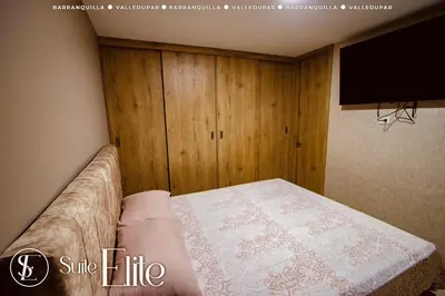 a bedroom with a bed and a flat screen tv at Suite Elite Barranquilla in Barranquilla