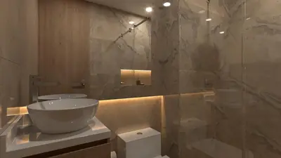 a bathroom with a toilet and a glass shower at Suite Elite Barranquilla in Barranquilla