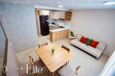 a living room with a table and a couch at Suite Elite Barranquilla in Barranquilla