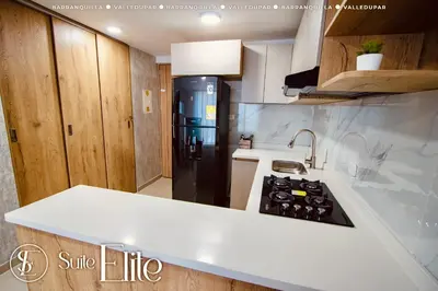 a kitchen with a white counter top and a black refrigerator at Suite Elite Barranquilla in Barranquilla
