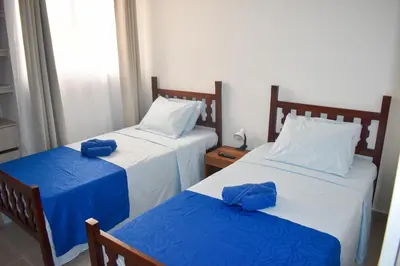 two beds in a room with blue bows on them at Comfortable apartment close to the beach 2 rooms in Cartagena de Indias