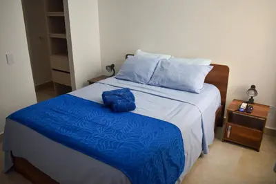 a bedroom with a bed with blue sheets at Comfortable apartment close to the beach 2 rooms in Cartagena de Indias
