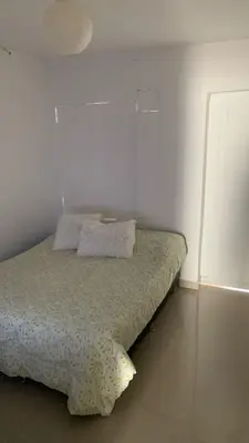 a small bedroom with a bed in a white room at Apartamento Ciudad Jardin Barranquilla in Barranquilla