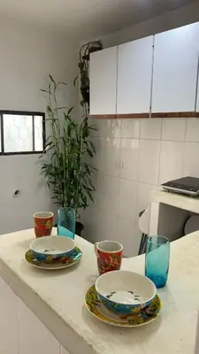a kitchen counter with two plates and bowls on it at Apartamento Ciudad Jardin Barranquilla in Barranquilla