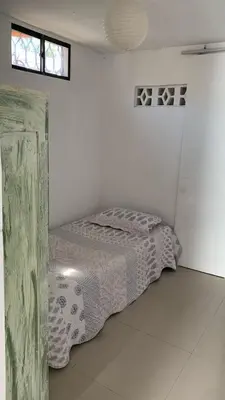a bedroom with a bed in a white room at Apartamento Ciudad Jardin Barranquilla in Barranquilla