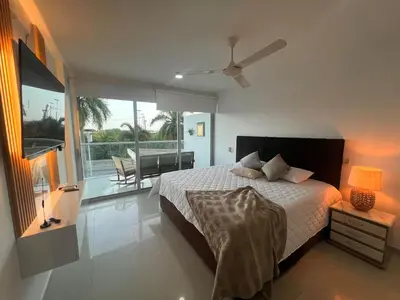 a bedroom with a bed and a view of a balcony at Luxury, Central y Exclusivo1 Linea Playa Privada in Cartagena de Indias
