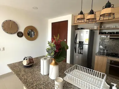 a kitchen with a counter top with a refrigerator at Luxury, Central y Exclusivo1 Linea Playa Privada in Cartagena de Indias