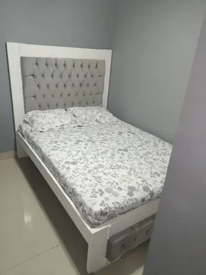 a bed in a room with a white bed frame at 5 minutos del Castillo san Felipe in Cartagena de Indias
