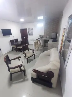 a living room with a white couch and chairs at 5 minutos del Castillo san Felipe in Cartagena de Indias