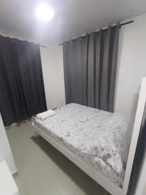 a bed in a room with black curtains at 5 minutos del Castillo san Felipe in Cartagena de Indias