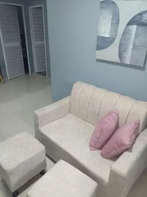 a white couch with pink pillows in a living room at 5 minutos del Castillo san Felipe in Cartagena de Indias