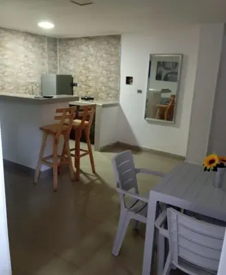 a kitchen with a table and chairs and a counter at 5 minutos del Castillo san Felipe in Cartagena de Indias