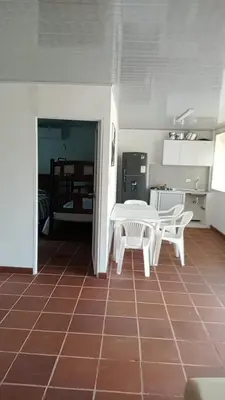 a kitchen with a table and two chairs in a room at Dulce Barú in Cartagena de Indias