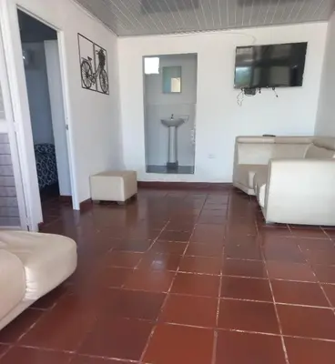a living room with a brown tiled floor at Dulce Barú in Cartagena de Indias